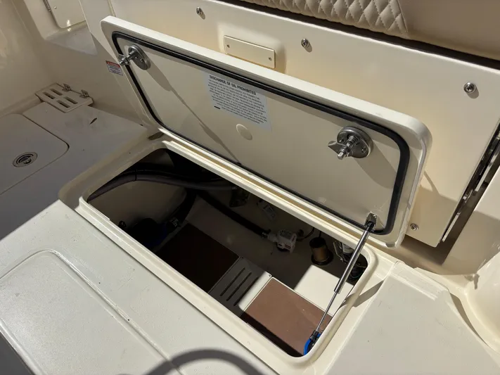  Yacht Photos Pics 2025 Scout 260 LXF boat storage compartment with open hatch, showcasing interior details.