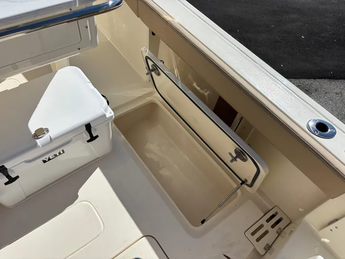  Yacht Photos Pics 2025 Scout 260 LXF boat interior with storage compartment and cooler.