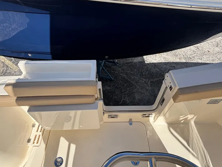  Yacht Photos Pics 2025 Scout 260 LXF boat interior with open transom door and seating area.