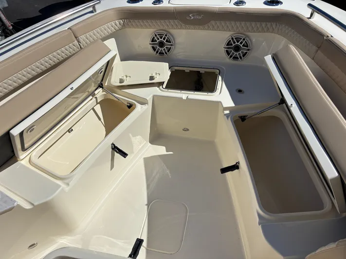  Yacht Photos Pics 2025 Scout 260 LXF boat interior with open storage compartments and cushioned seating.