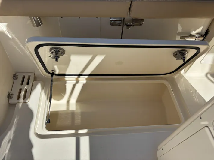  Yacht Photos Pics 2025 Scout 260 LXF boat storage compartment, open and empty, with beige interior.