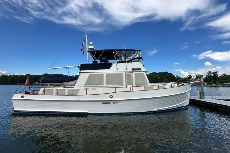 30 West Yacht Photos Pics 1991 Grand Banks 49 Classic yacht docked on a sunny day with clear skies.