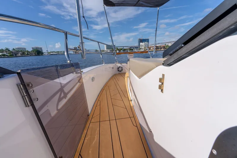 Custom Order Your 347 Today! Yacht Photos Pics Modern Hanover 347 yacht deck with sleek design, overlooking a scenic waterfront.