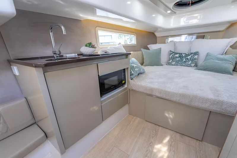 Custom Order Your 347 Today! Yacht Photos Pics Luxurious interior of Hanover 347 yacht, featuring a cozy bed, kitchenette, and modern design.