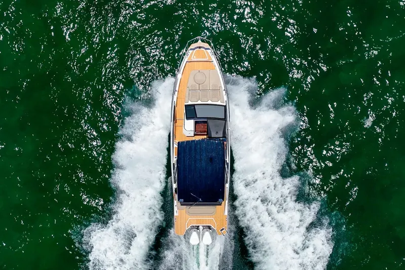 Custom Order Your 347 Today! Yacht Photos Pics Aerial view of Hanover 347 boat cruising on green water, 2026 model.