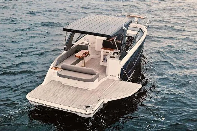 Custom Order Your 347 Today! Yacht Photos Pics 2025 Hanover 347 Inboard boat cruising on open water, rear view.