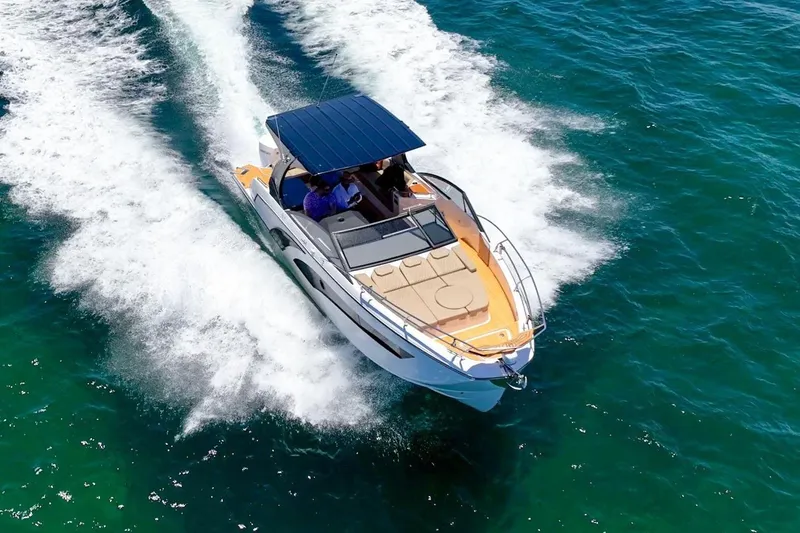 Custom Order Your 347 Today! Yacht Photos Pics 2026 Hanover 347 boat cruising on clear blue water.