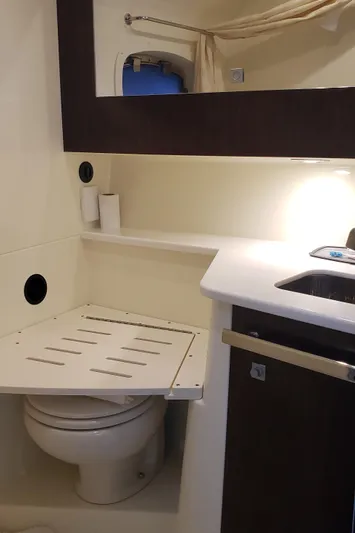  Yacht Photos Pics 2016 Monterey 360 Sport Coupe bathroom with toilet, sink, and mirror.