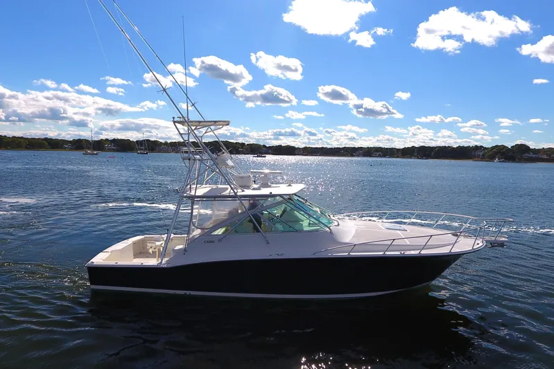 Moving Violation Yacht Photos Pics 2008 Cabo 40 yacht on a sunny day, cruising on calm waters.