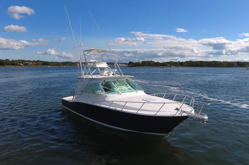 Moving Violation Yacht Photos Pics 2008 Cabo 40 boat on calm water under a clear blue sky.