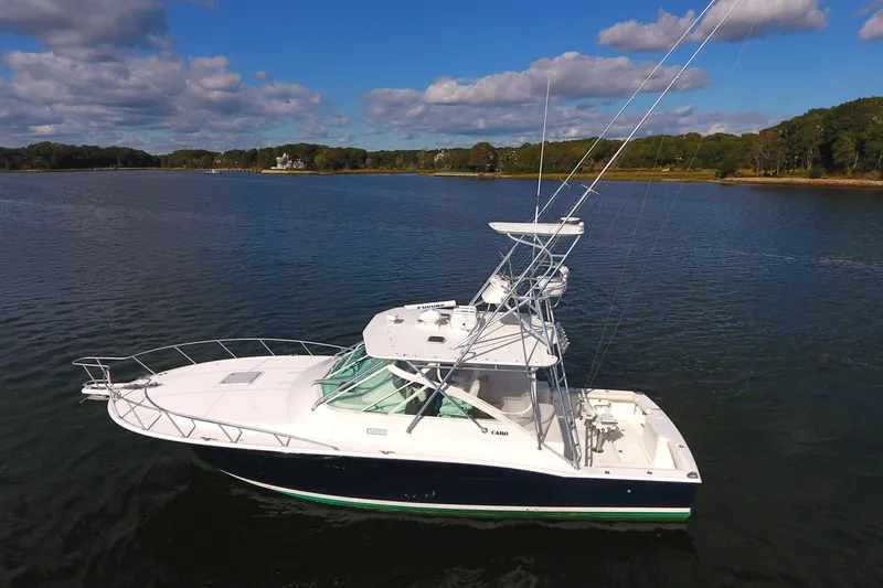 Moving Violation Yacht Photos Pics 2008 Cabo 40 boat on calm water under a partly cloudy sky.