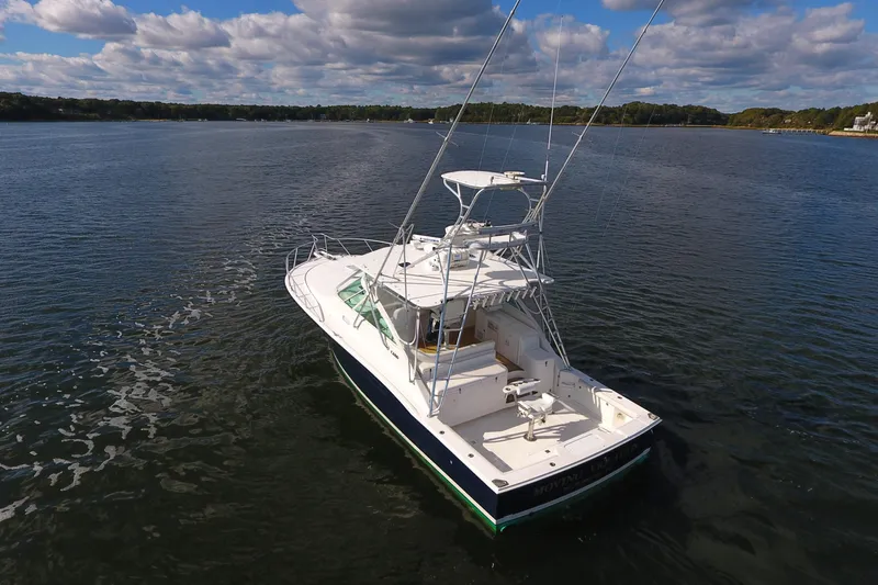 Moving Violation Yacht Photos Pics 2008 Cabo 40 boat on calm water under a partly cloudy sky.