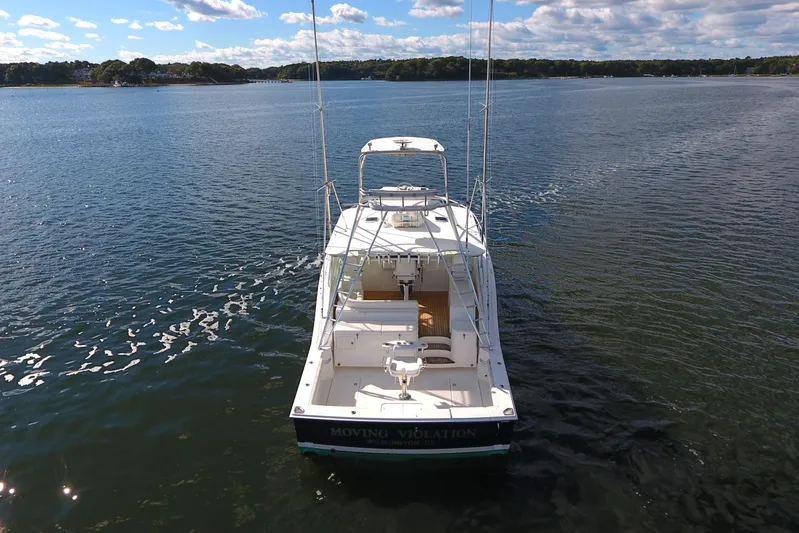 Moving Violation Yacht Photos Pics 2008 Cabo 40 boat on calm water under a partly cloudy sky.