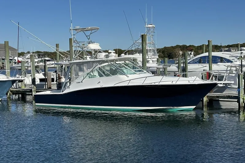 Moving Violation Yacht Photos Pics 2008 Cabo 40 boat docked in a marina under clear blue skies.