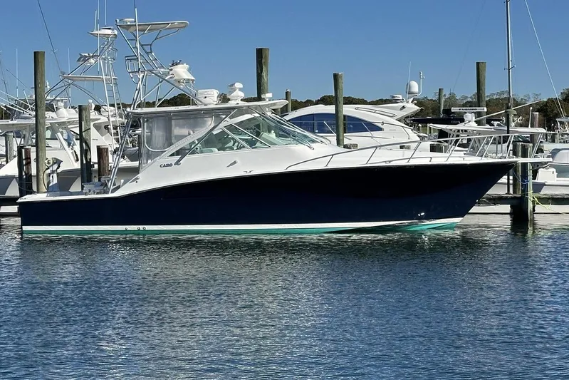 Moving Violation Yacht Photos Pics 2008 Cabo 40 boat docked at marina, clear blue sky background.