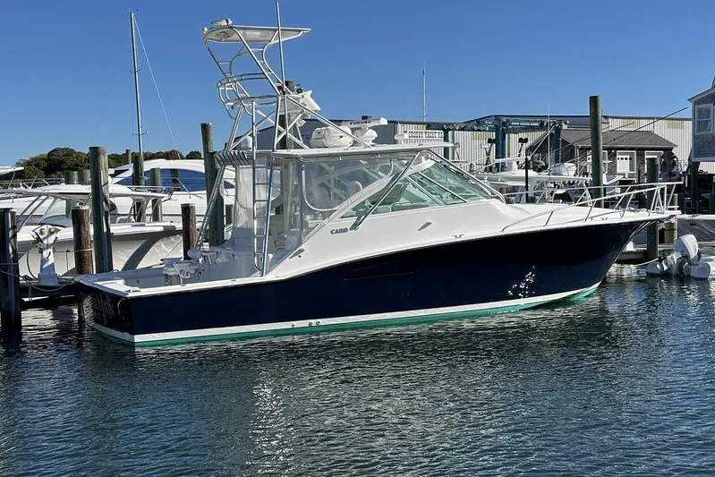 Moving Violation Yacht Photos Pics 2008 Cabo 40 boat docked at marina under clear blue sky.