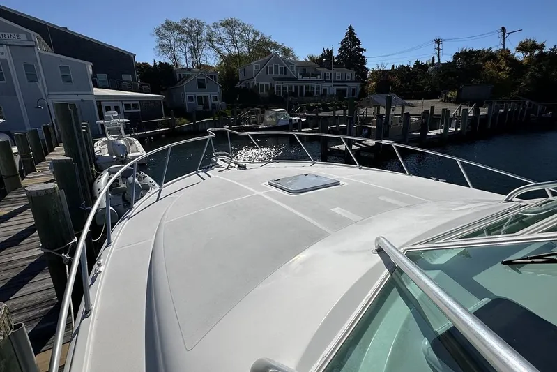 Moving Violation Yacht Photos Pics 2008 Cabo 40 boat docked at a marina with waterfront houses in the background.