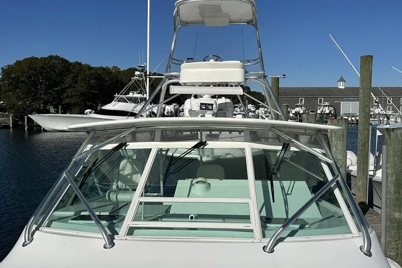 Moving Violation Yacht Photos Pics 2008 Cabo 40 boat docked at marina, clear sky, waterfront view.