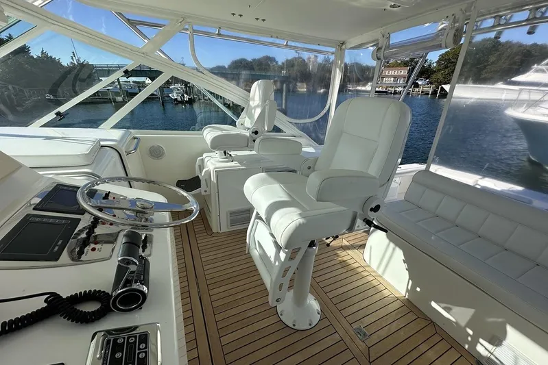Moving Violation Yacht Photos Pics Luxurious 2008 Cabo 40 yacht interior with white seating and wooden flooring.