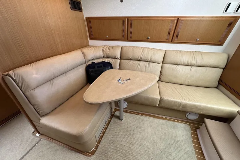 Moving Violation Yacht Photos Pics Luxurious interior of 2008 Cabo 40 yacht with beige leather seating and wooden accents.