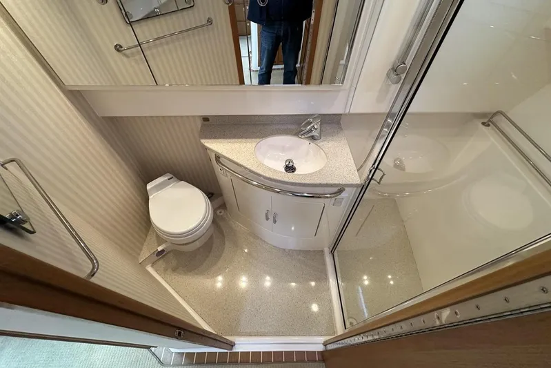 Moving Violation Yacht Photos Pics Compact bathroom in a 2008 Cabo 40 yacht with shower, sink, and toilet.