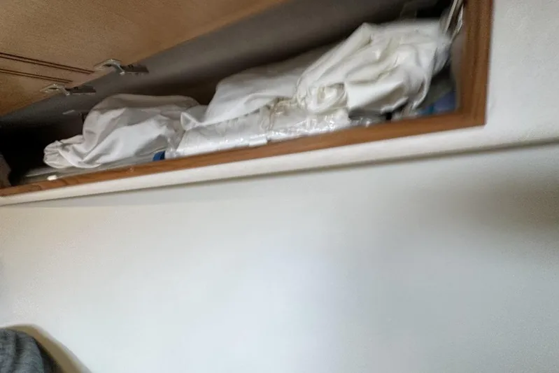 Moving Violation Yacht Photos Pics Storage compartment with folded linens inside a 2008 Cabo 40 boat.