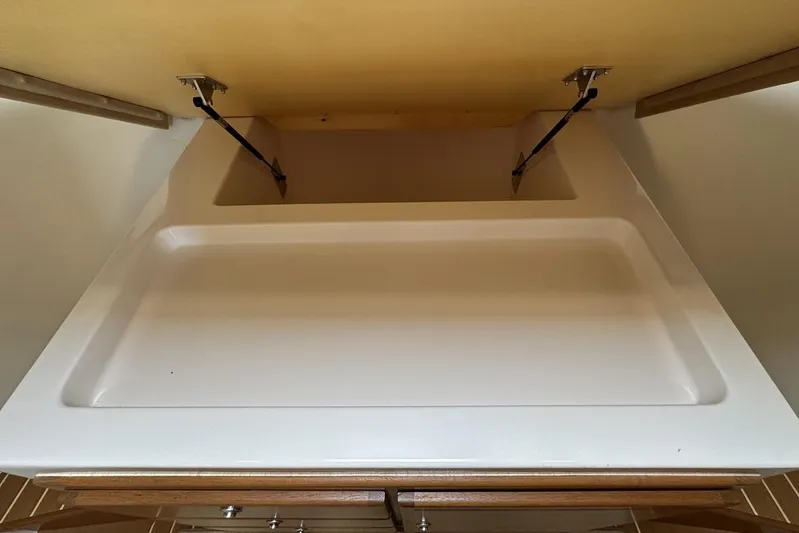 Moving Violation Yacht Photos Pics 2008 Cabo 40 interior storage compartment with open lid and hydraulic hinges.