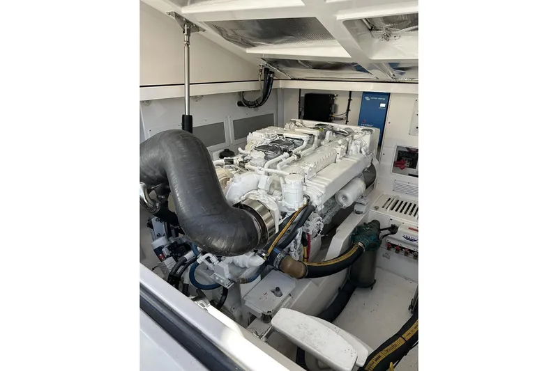 Moving Violation Yacht Photos Pics Engine room of a 2008 Cabo 40 boat, showcasing a powerful marine engine.