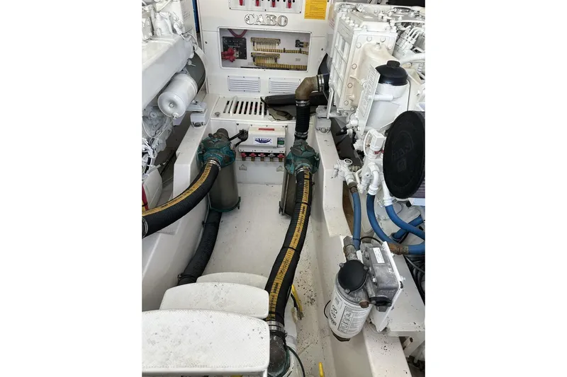 Moving Violation Yacht Photos Pics Engine room of a 2008 Cabo 40 boat, showcasing mechanical components and hoses.