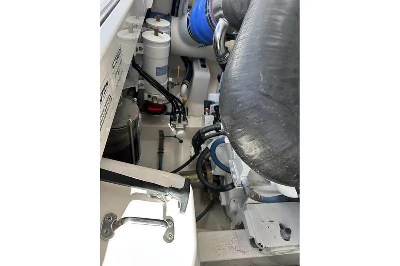 Moving Violation Yacht Photos Pics Engine compartment of a 2008 Cabo 40 boat, showcasing hoses and components.