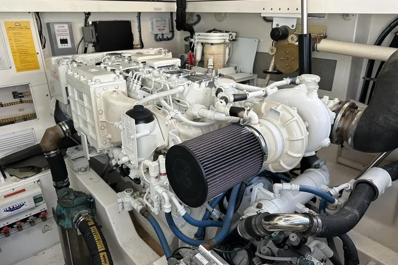 Moving Violation Yacht Photos Pics Engine room of a 2008 Cabo 40 boat, showcasing detailed mechanical components.