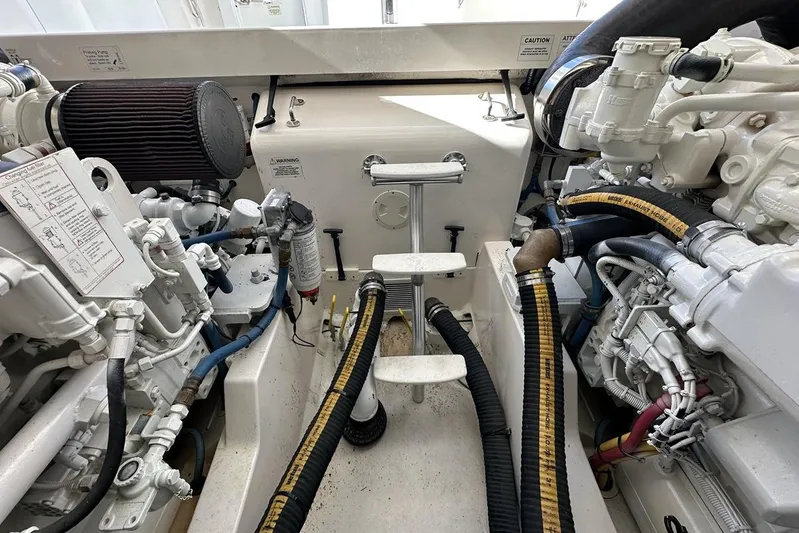 Moving Violation Yacht Photos Pics Engine room of a 2008 Cabo 40 boat, showcasing mechanical components and hoses.