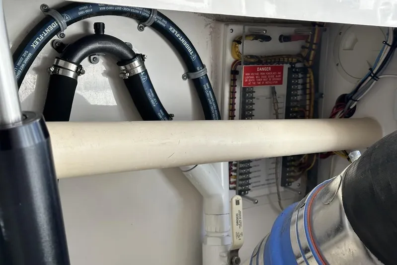 Moving Violation Yacht Photos Pics Engine compartment of a 2008 Cabo 40 boat, showing hoses and wiring.