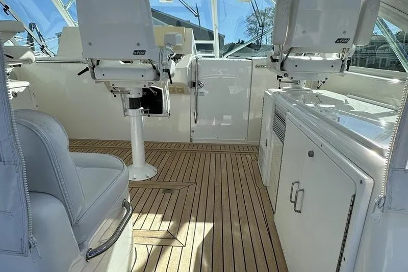 Moving Violation Yacht Photos Pics Luxurious 2008 Cabo 40 yacht interior with sleek white seating and wooden flooring.