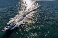 Luxurious 2020 Pershing 8X yacht cruising on open sea, leaving a dynamic wake.