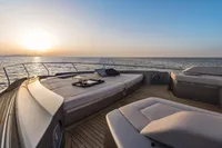 Luxurious 2020 Pershing 8X yacht deck at sunset, featuring elegant seating and ocean views.