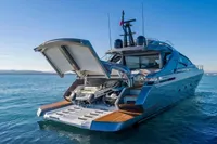Luxury 2020 Pershing 8X yacht with open garage and tender on calm sea.
