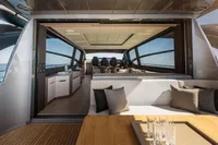 Luxurious interior of 2020 Pershing 8X yacht with modern seating and panoramic windows.