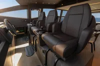 Luxurious interior of 2020 Pershing 8X yacht with plush seating and modern controls.