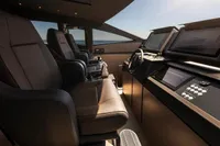 Luxurious interior of 2020 Pershing 8X yacht with modern helm and leather seating.
