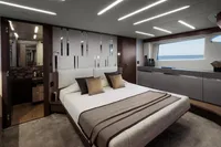 Luxurious bedroom interior of 2020 Pershing 8X yacht with modern design and sea view.