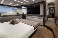 Luxurious bedroom interior of 2020 Pershing 8X yacht with modern design and large window.