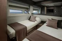 Luxurious twin cabin interior on 2020 Pershing 8X yacht, featuring modern design and ocean view.