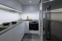 Modern kitchen interior on 2020 Pershing 8X yacht, featuring sleek cabinetry and stainless steel appliances.