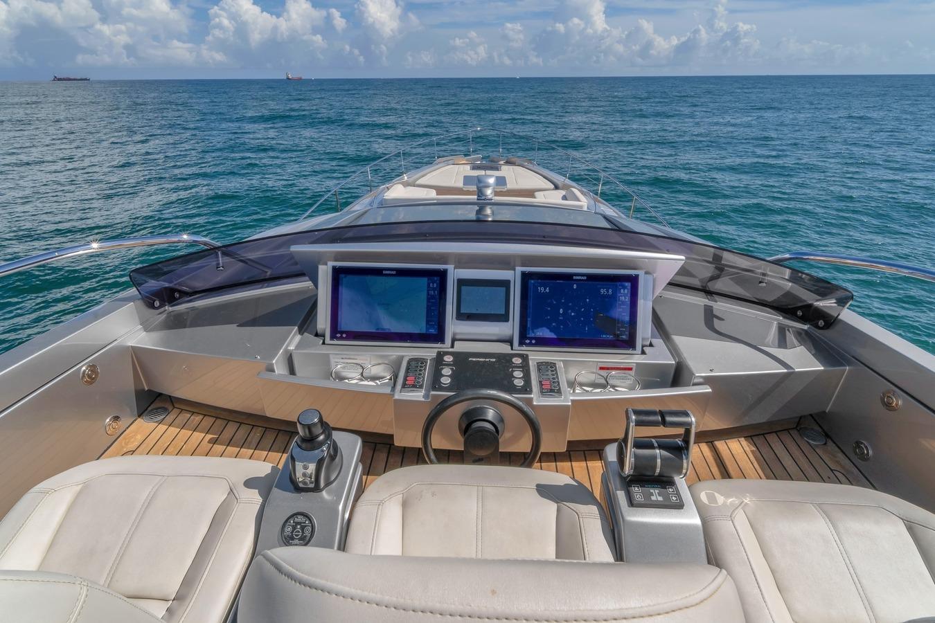 Cockpit view of 2020 Pershing 8X yacht with navigation screens and ocean backdrop.