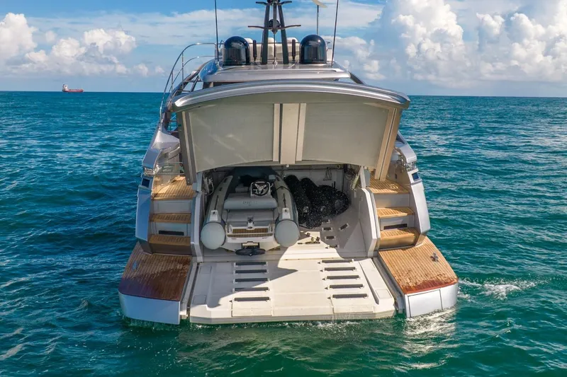 Alexandra Yacht Photos Pics 2020 Pershing 8X yacht with open garage, floating on blue ocean waters.