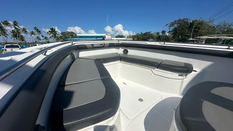  Yacht Photos Pics 2014 Boston Whaler 350 Outrage boat interior with gray seating under clear blue sky.