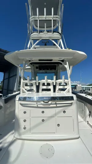 Yacht Photos Pics 2014 Boston Whaler 350 Outrage boat with tower and rod holders under clear blue sky.