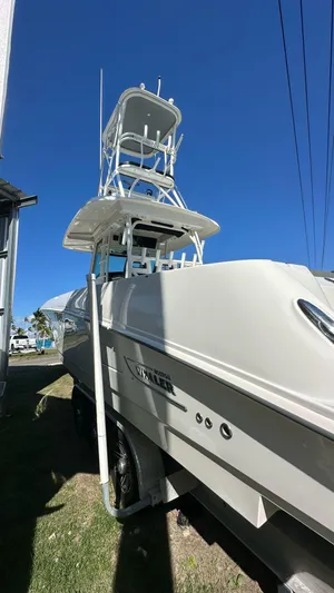  Yacht Photos Pics 2014 Boston Whaler 350 Outrage boat with tower against clear blue sky.