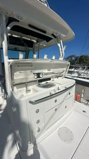  Yacht Photos Pics 2014 Boston Whaler 350 Outrage boat with open storage and sink on deck.